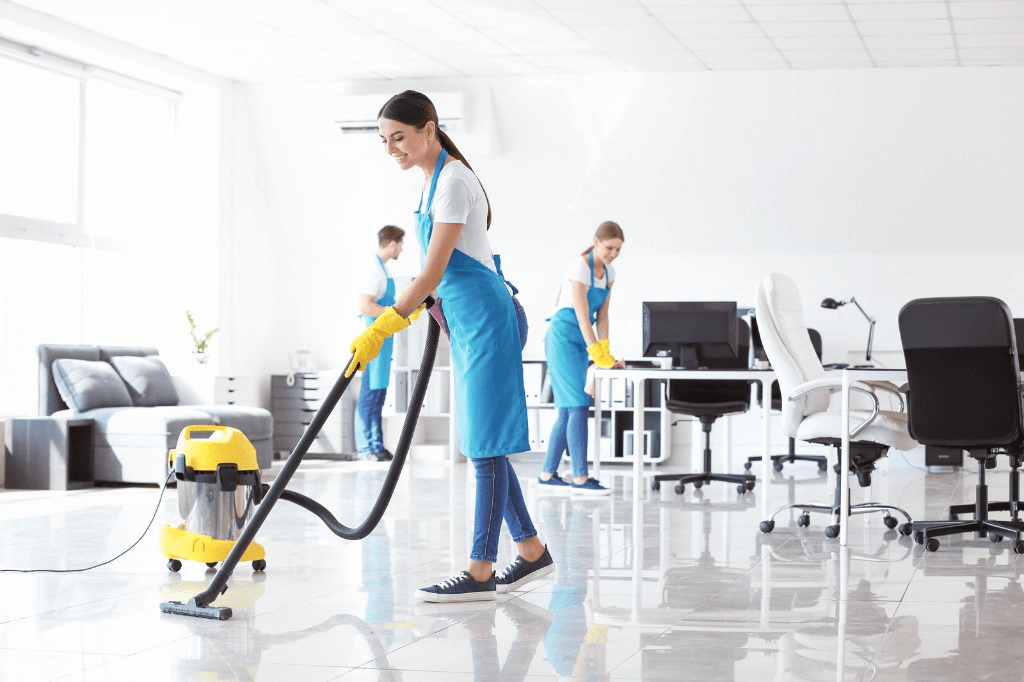 Cleaning crew vacuuming and wiping down a commercial office